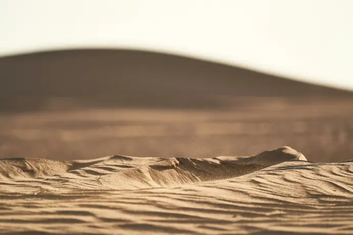 A blurry photo of sand dunes in the desert